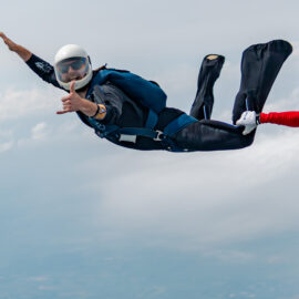 A skydiver posing for a photo mid-jump