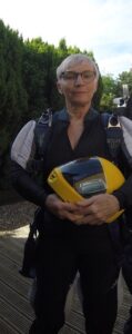 A woman holding a skydive helmet 