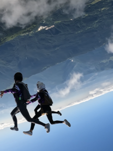 Three skydivers during a jump