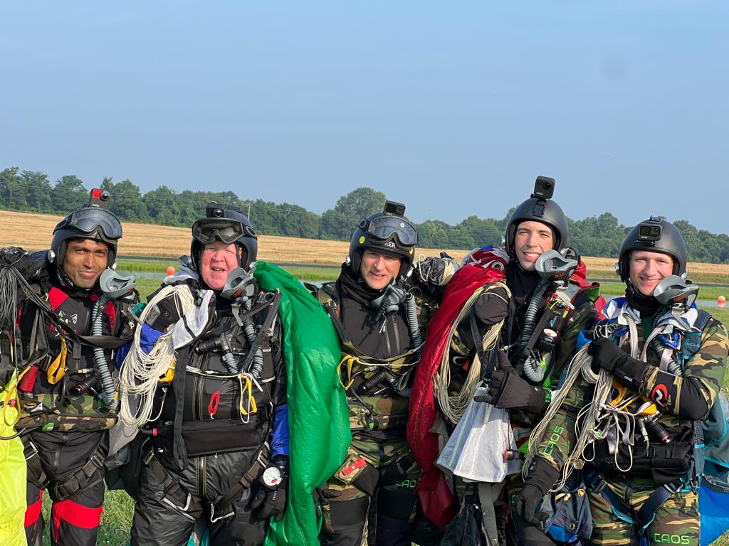 A group of skydivers at a drop zone