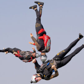 Three skydivers in freefall, upside down