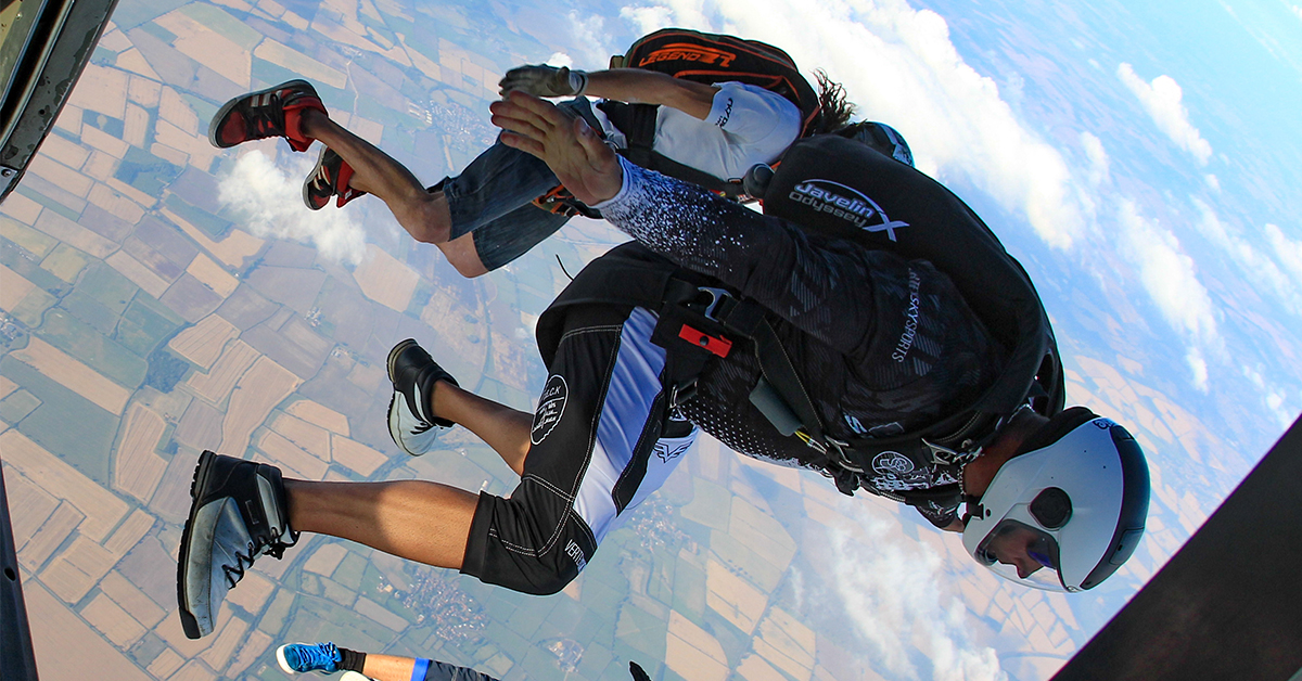 Skydiver jumps from a plane, seen through the plane door