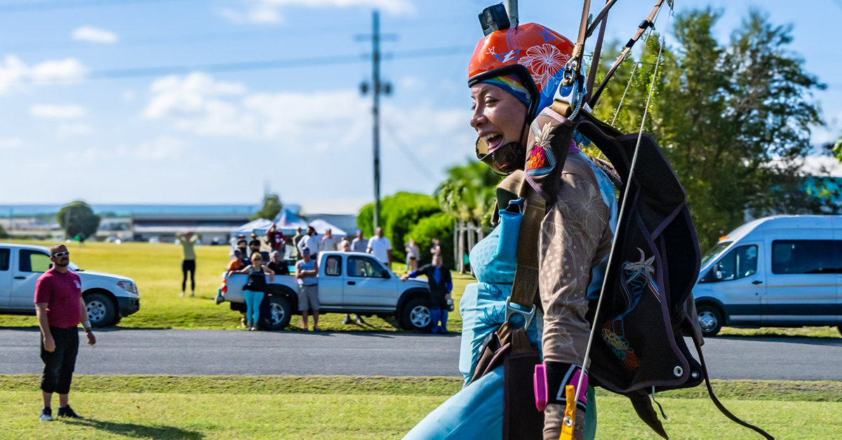 Happy skydiver touches down in front of onlookers