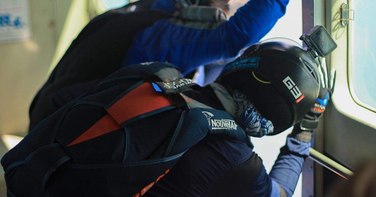 A skydiver wearing a helmet cam, ready to jump