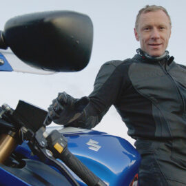 Andy Torbet poses with his Suzuki motorcycle and a peregrine falcon