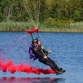 Andy Torbet about to touch down on water, trailing red smoke