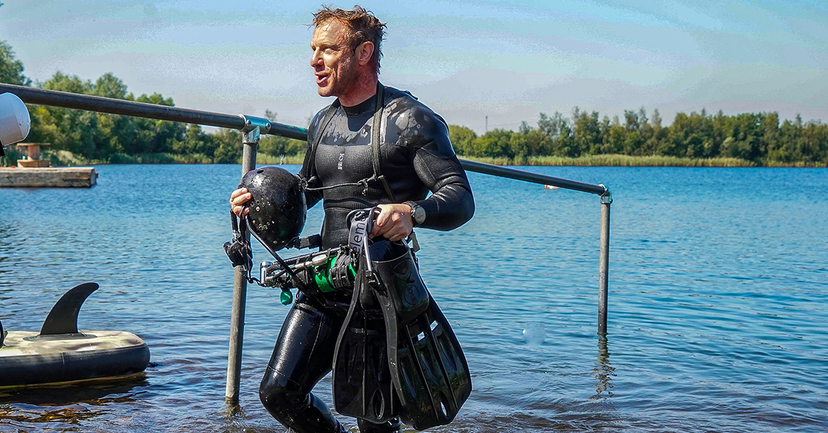 Andy Torbet emerges from the water, gear in hand